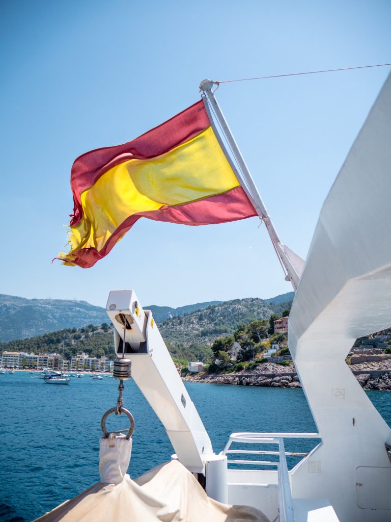 A Spanish flag hung on the back of a yacht